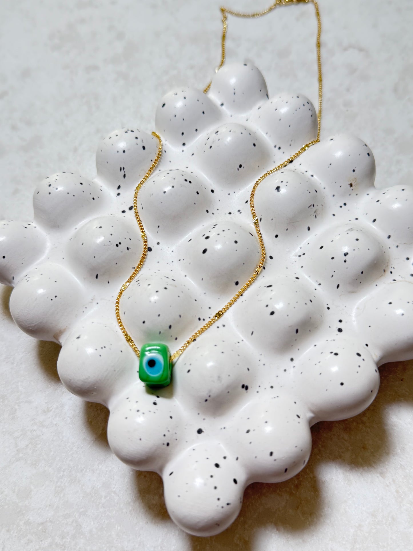 Green square evil eye